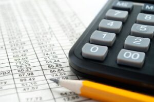 calculator, pencil and spreadsheet