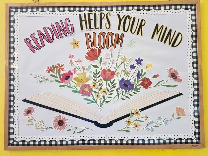 bulletin board saying "Reading Helps your Mind Bloom" with white background and paper cutouts of flowers